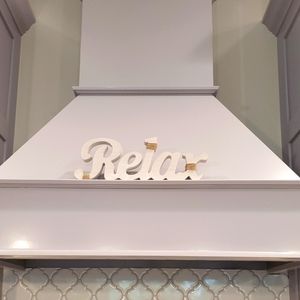 Relax whitewashed sign